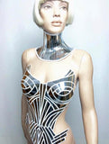 Futuristic top in mirror pvc combined with white artdeco motifs